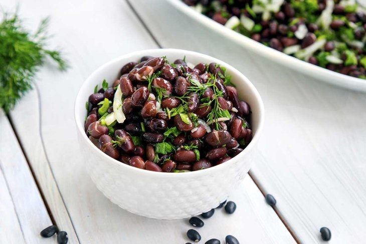 Black bean salad on white background.